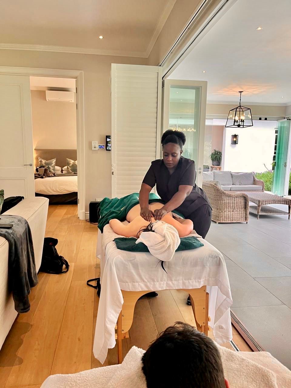 Nakai providing a massage treatment at a Cape Town client location